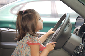 Little girl play driving in a car