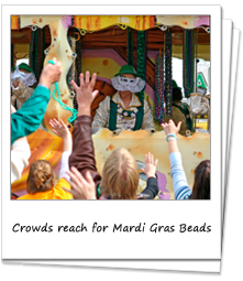 Crowds reach for Mardi Gras Beads from a passing float