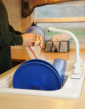 Washing dishes in an RV.