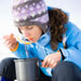 Woman eating soup outdoors in the winter