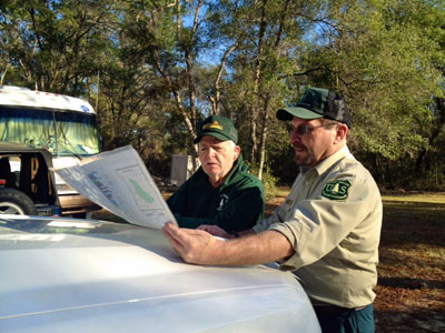 Brett Bush, Ocala National Forest Ranger studying a Forest Service Map