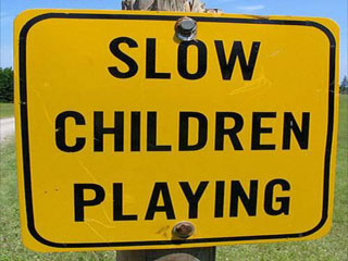 Campground sign that reads "Slow Children Playing"