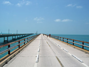 People biking and hiking the Seven Mile Bridge in the Florida Keys with the views of aqua blue water to the horizon