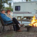 Elderly couple at their campsite enjoying a campfire