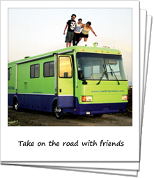 College kids standing on the roof of a green RV
