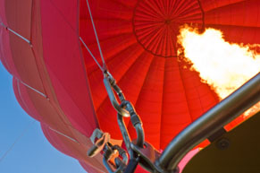Flame filling a rising red balloon