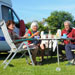 Four seniors having breakfast together at a campsite