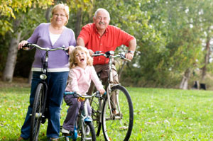 Grandparents biking with their granddaughter