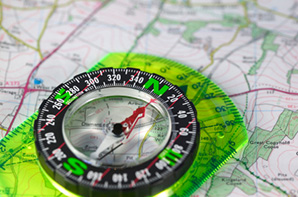 Green compass on a map