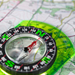 Green compass on a map
