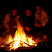People around a blazing campfire