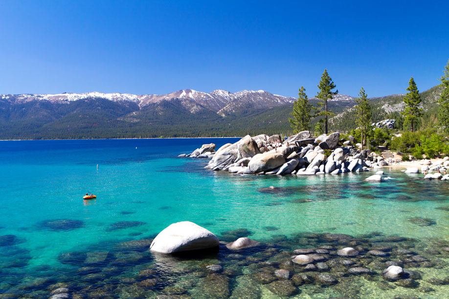 Beautiful blue Lake Tahoe with mountains framing the horizon