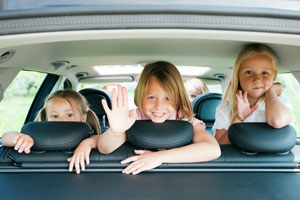 3 little girls in back seat of car