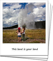Two young girls watching Old Faithful erupt