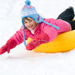 Young girl snow tubing