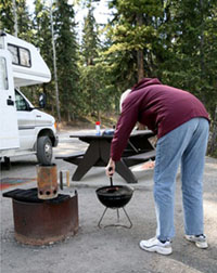 Man cooking on a camp grill