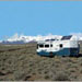 RV with Solar Panels on the roof near snow covered mountains
