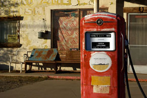 Old red gas pump in station