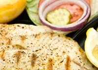 Grilled tilapia with salad and lemon