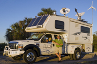 Brian Brawdy stands outside his wind and solar powered RV