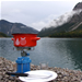 Pot on camping stove by scenic mountain lake