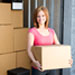 Young woman holding a box at a storage unit