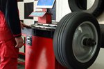 Tire balance machine inspection done by a mechanic