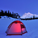 Lit tent perched on snow