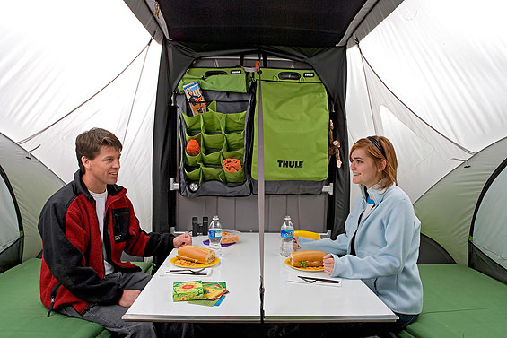Interior view of the SylvanSport GO Camper Trailer with a couple sitting at a table