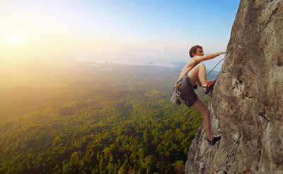 Climber on a rock with background scenic view
