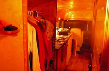 Interior shot of RV bus - wardrobe and kitchen