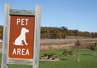 A park sign that states 'Pet Area'.