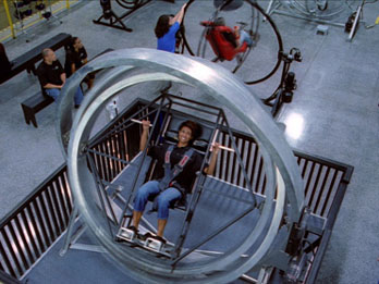 Lady on Multi Axis Trainer on Astronaut Training Experience Program, Kennedy Space Center