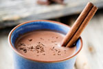 Hot chocolate with a cinnamon dipped in it