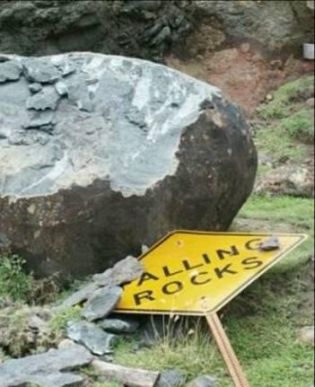 Falling Rocks warning sign flattened with rocks