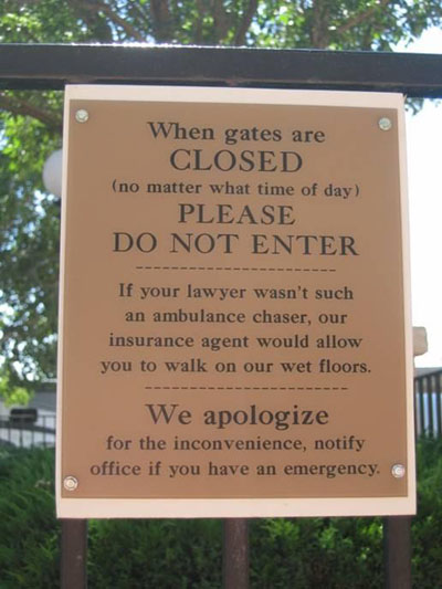 Campground sign that reads "When gates are closed please do not enter. If your lawyer wasn't such an ambulance chaser, our insurance agent would allow you to walk on our wet floors. We apologize for the inconvenience, notify the office if you have an emergency"
