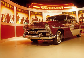 Old car infront of mock diner set