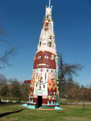 Large totem pole painted with faces and other patterns