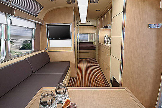 Interior of Airstream Land Yacht, front to back showing living area and bedroom