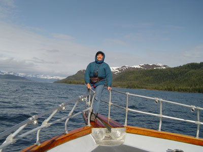 Malia Lane on bow of boat taking cruise on Alaskan glacier