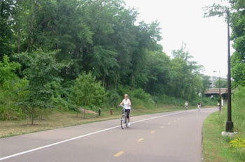 Lady riding a bike on Midtown Greenway Trail