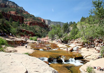 Families swimming and playing in Sliding Rock State Park, Sedona, AZ