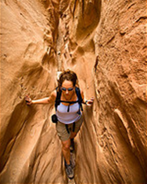 Woman hikes by rocks