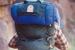 Camper with blue backpack