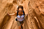 Woman hikes between rocks